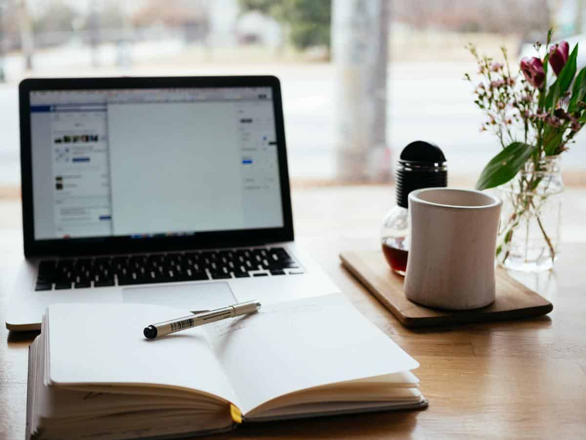 Laptop with notebook in front