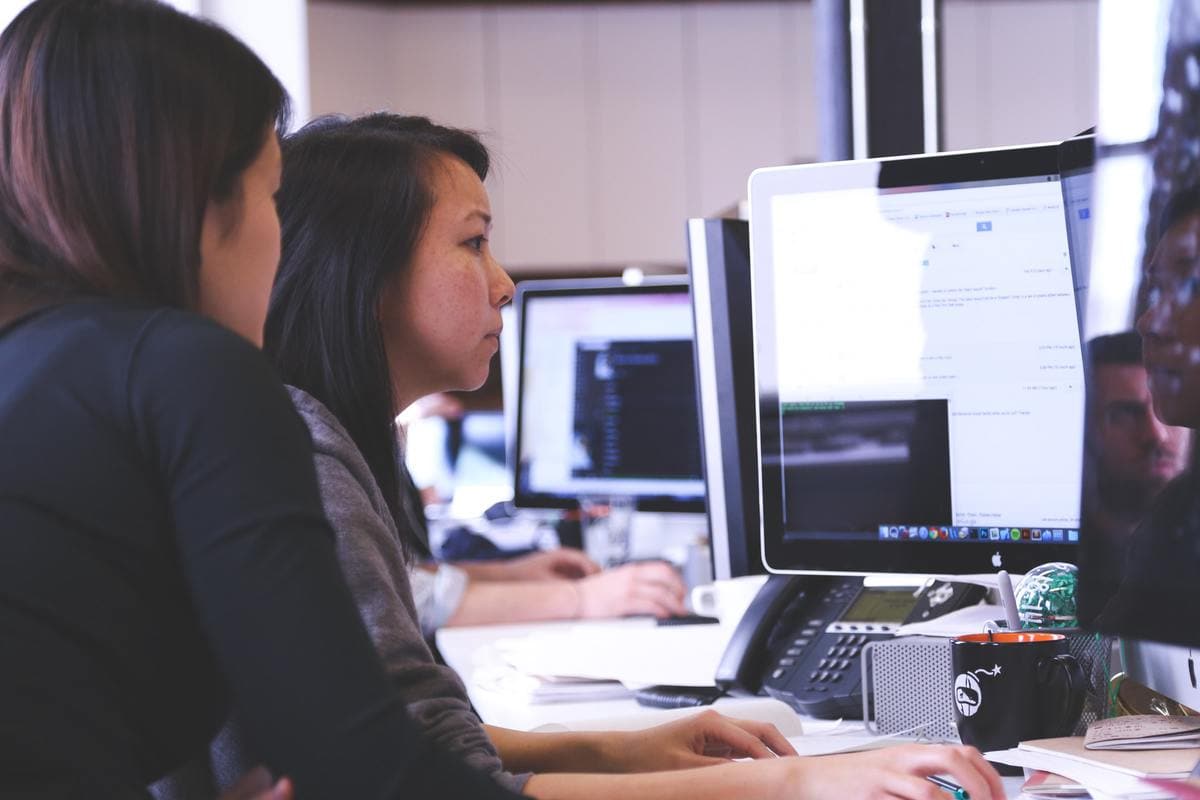 Two women looking at computer