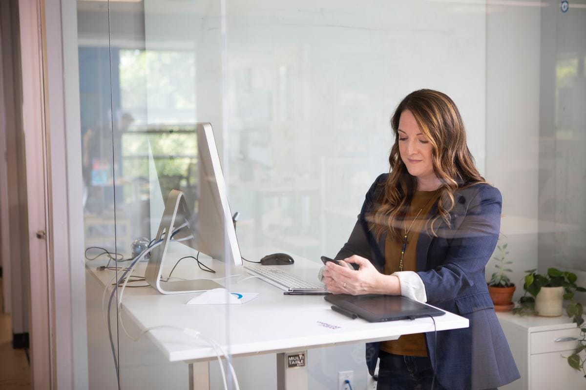 Woman looking at phone in office