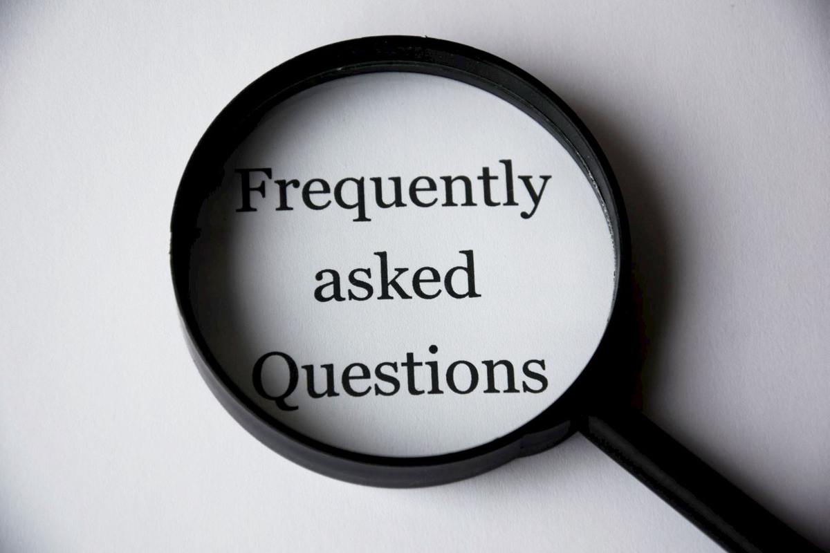 Magnifying glass and paper saying FAQ