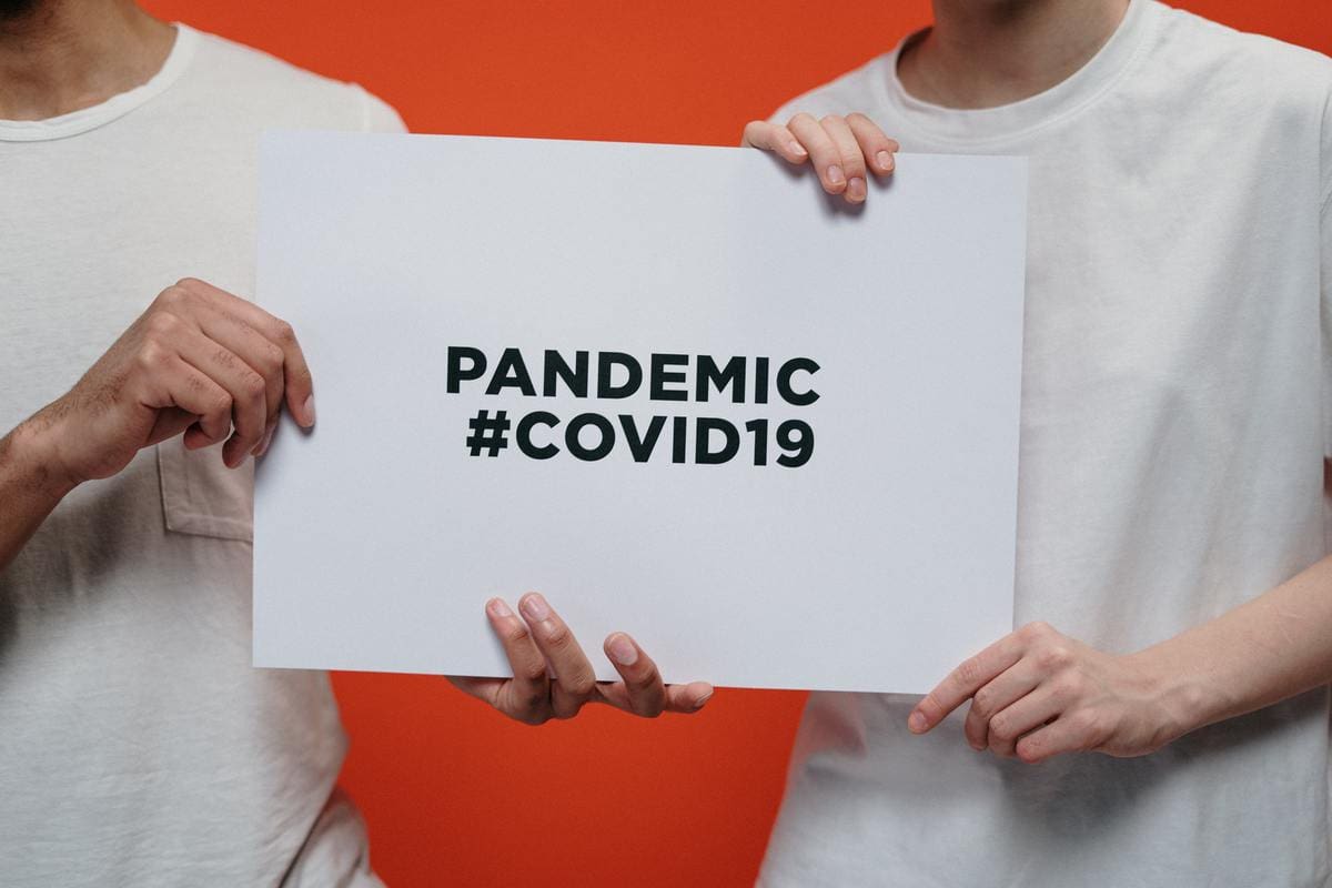 People holding COVID-19 sign
