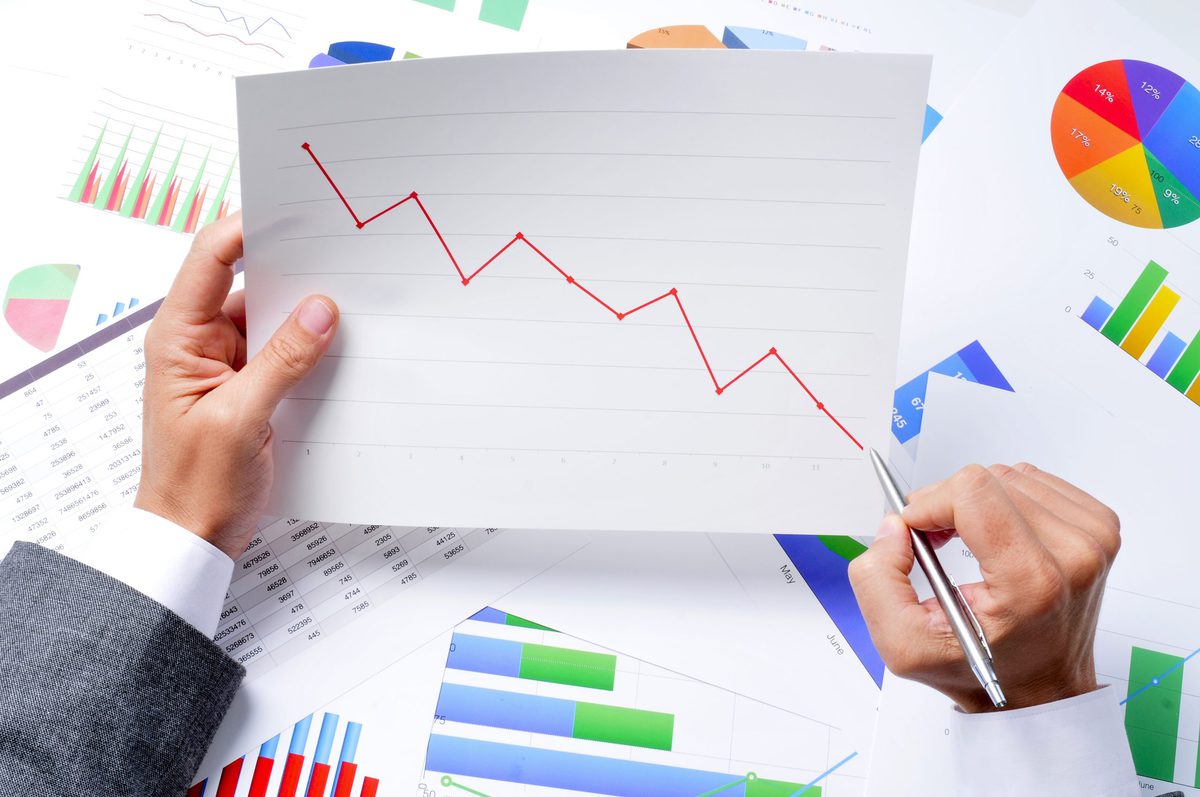 Person holding chart with downward trend