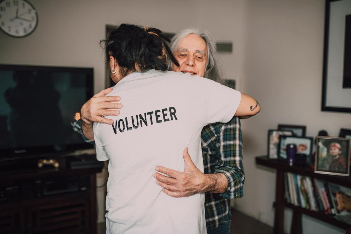Man hugging volunteer