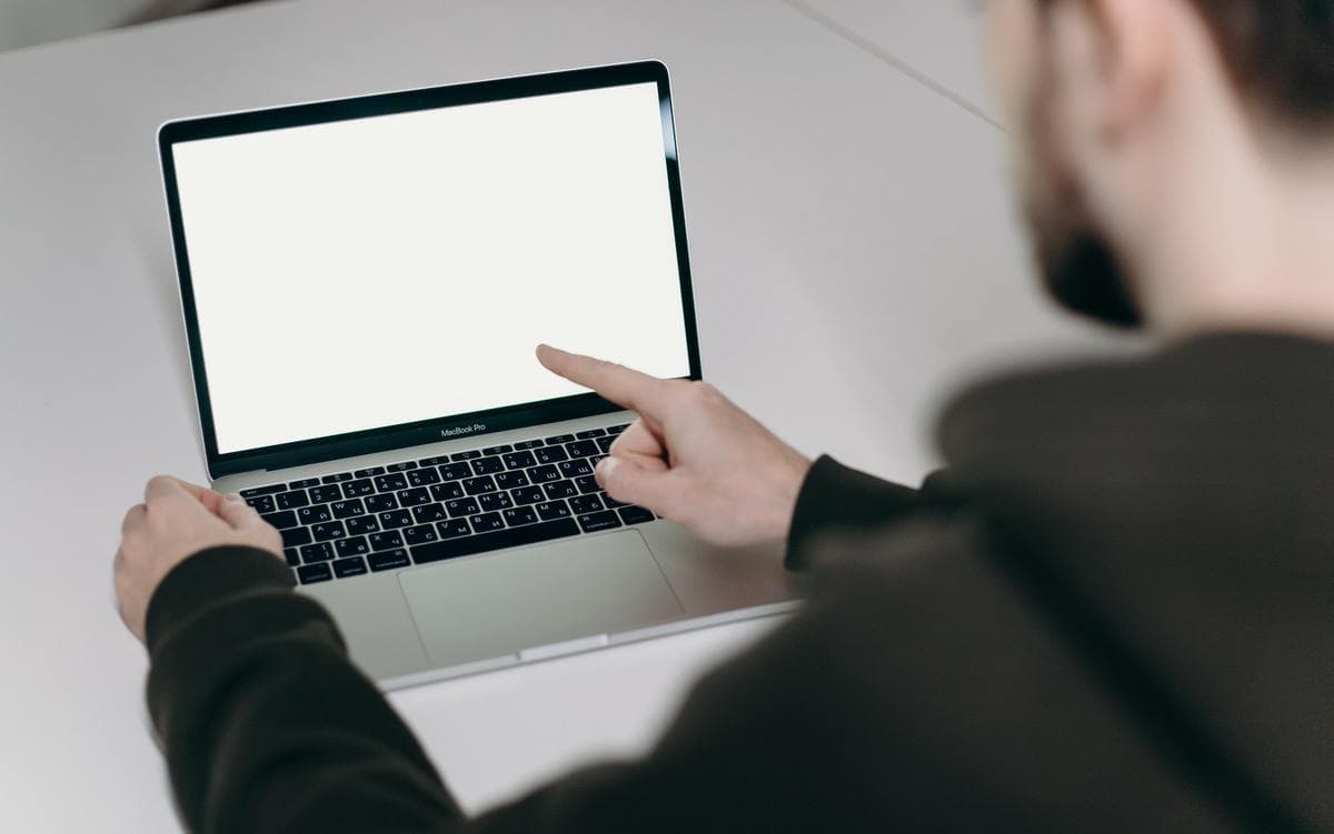 Man pointing at white screen