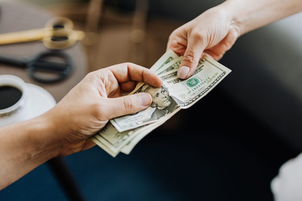 handing money hand to hand