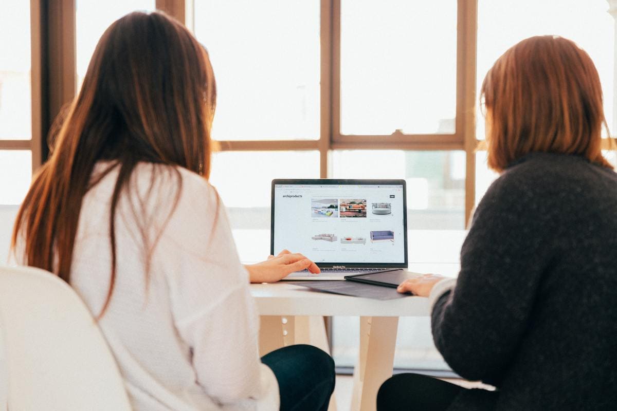 two girls looking at website