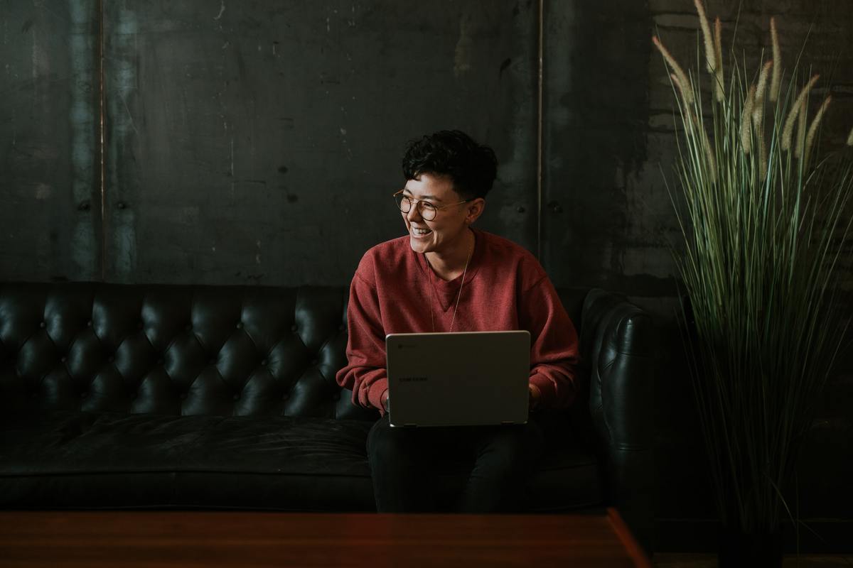 Man in red shirt using laptop