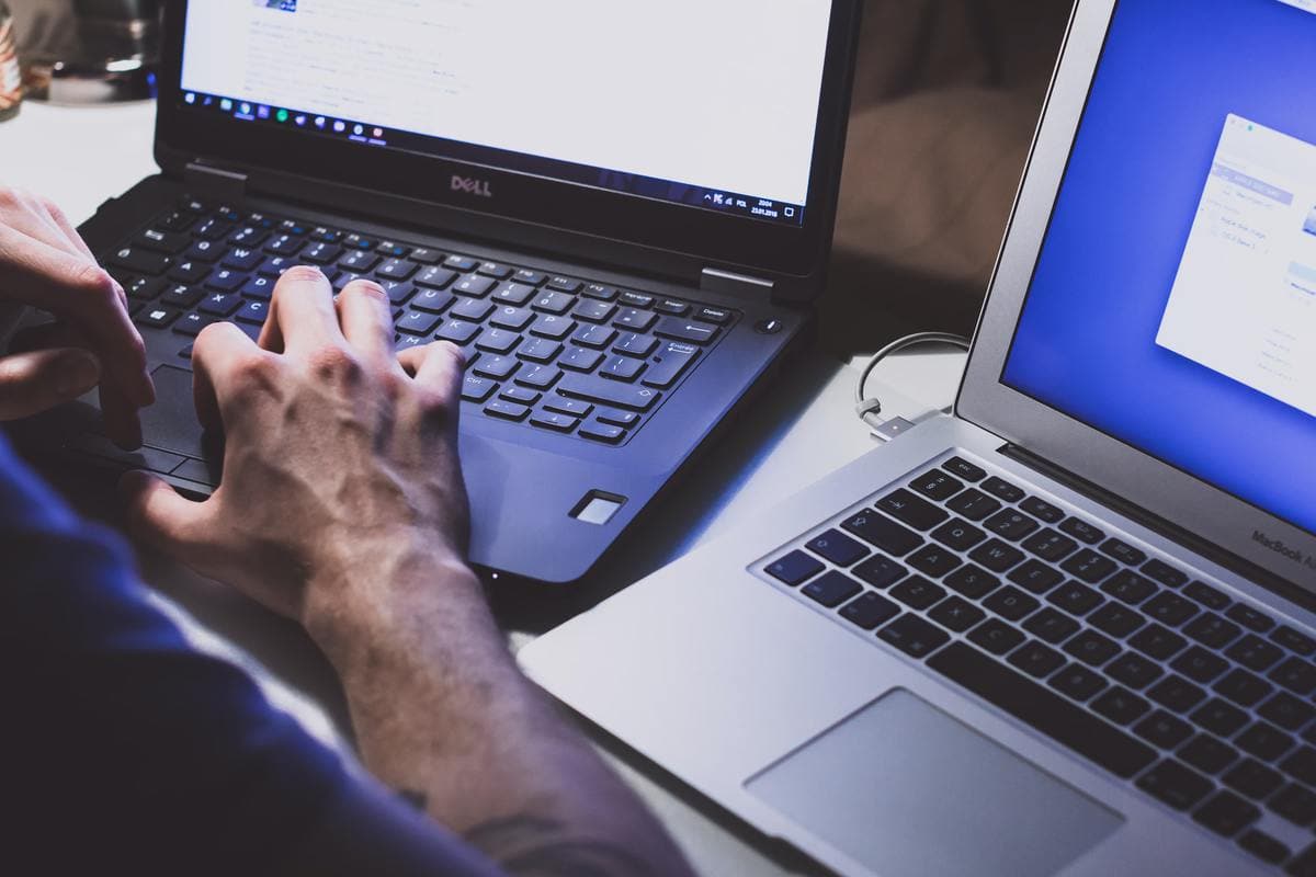 Person using black dell laptop