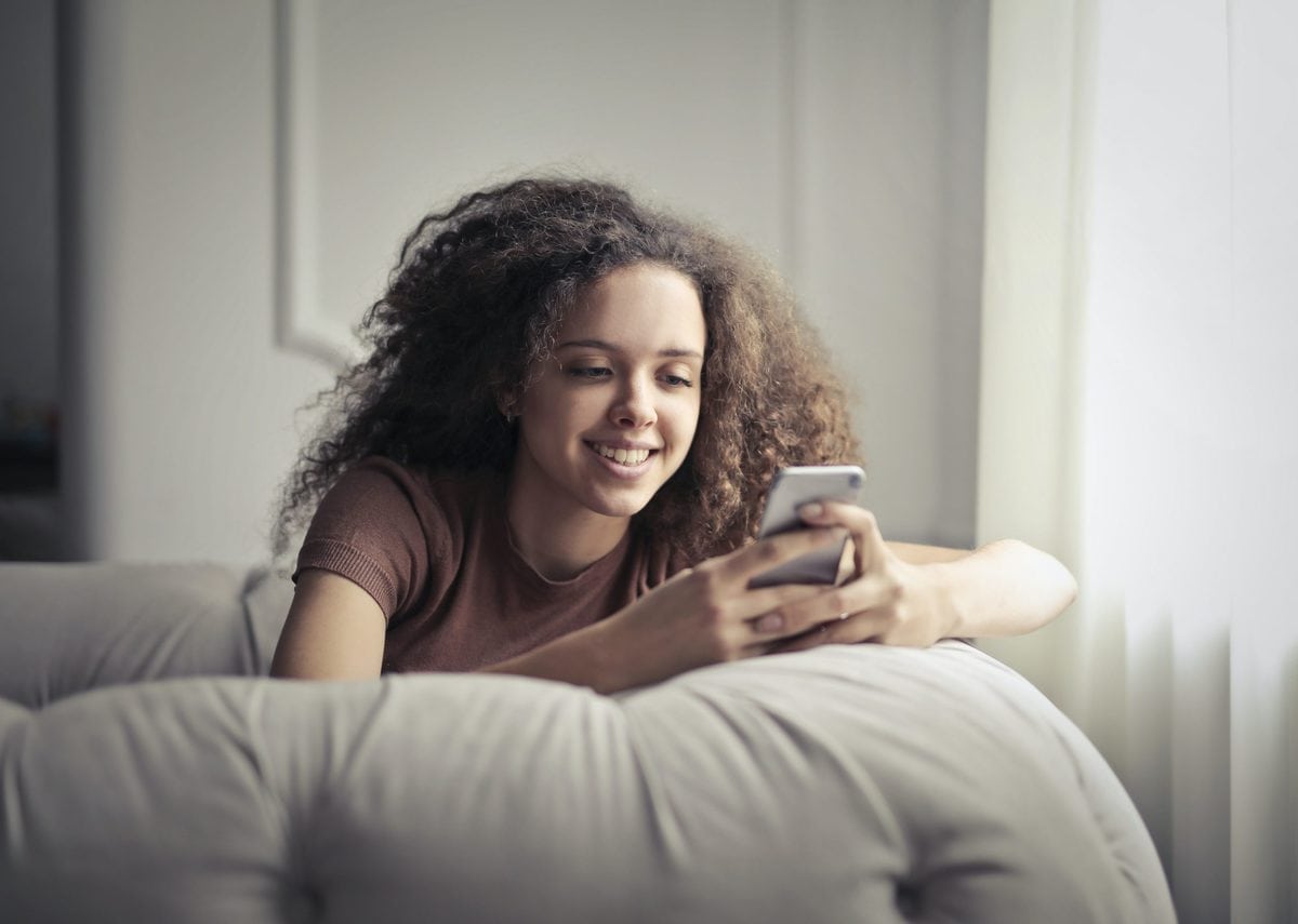 girl in grey shirt using phone